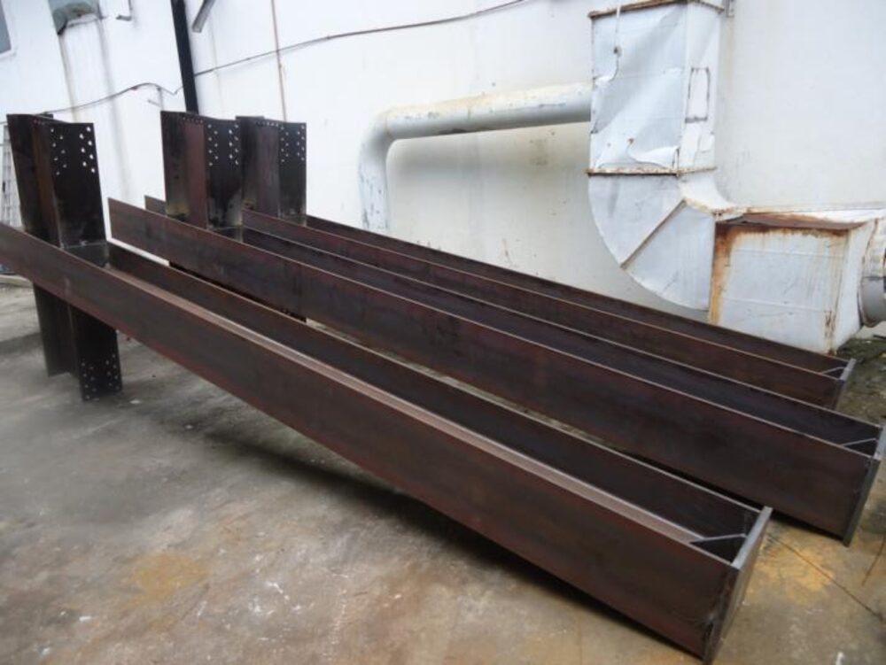 Structural steel beams staged for building construction